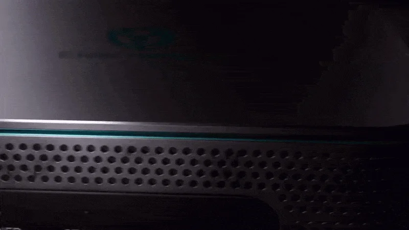 Close-up still of the probe's top edge, teal light seam and perforated side.